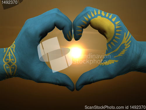 Image of Heart and love gesture by hands colored in kazakstan flag during