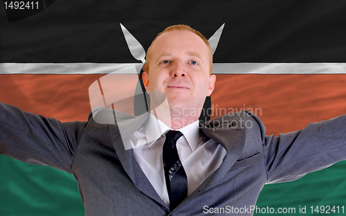 Image of happy businessman because of profitable investment in kenya stan