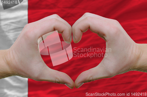 Image of Heart and love gesture showed by hands over flag of bahrain back