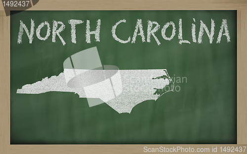Image of outline map of north carolina on blackboard 