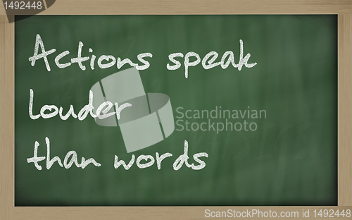 Image of " Actions speak louder than words " written on a blackboard