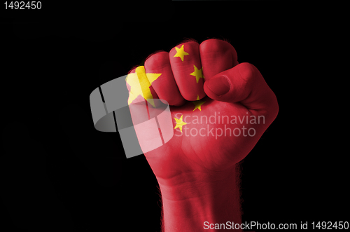 Image of Fist painted in colors of china flag