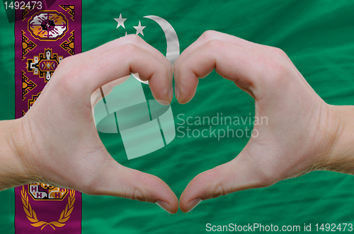 Image of Heart and love gesture showed by hands over flag of turkmenistan