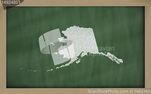 Image of outline map of alaska on blackboard 