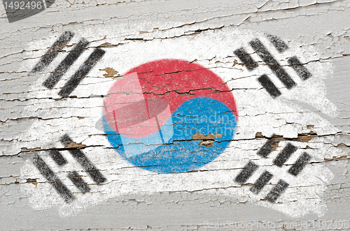 Image of flag of South Korea on grunge wooden texture painted with chalk 