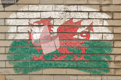 Image of flag of wales on grunge brick wall painted with chalk  