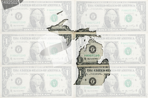 Image of Outline map of michigan with transparent american dollar banknot