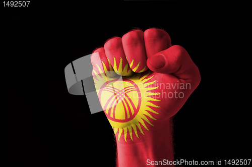 Image of Fist painted in colors of kyrghyzstan flag