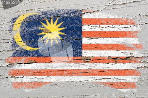 Image of flag of Malaysia on grunge wooden texture painted with chalk  