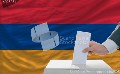Image of man voting on elections in armenia