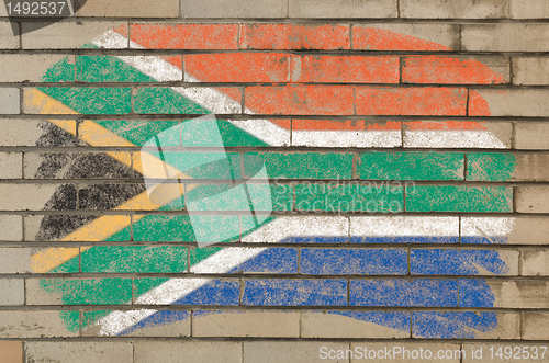 Image of flag of South Africa on grunge brick wall painted with chalk  