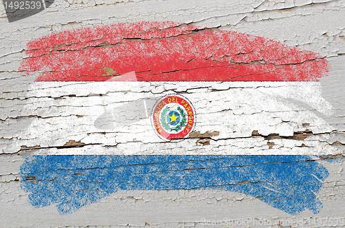 Image of flag of paraguay on grunge wooden texture painted with chalk  