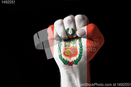 Image of Fist painted in colors of peru flag