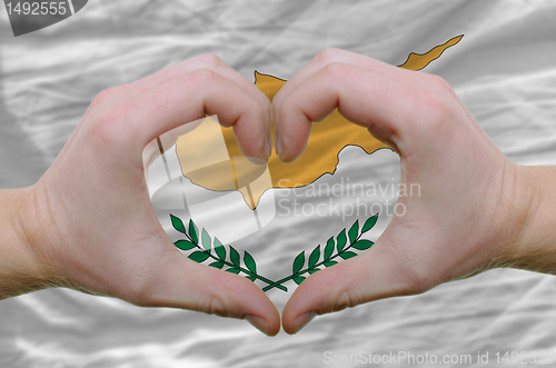 Image of Heart and love gesture showed by hands over flag of cyprus backg