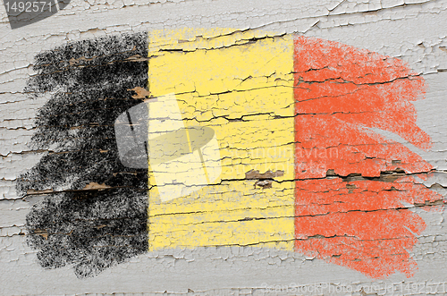 Image of flag of Belgium on grunge wooden texture painted with chalk  