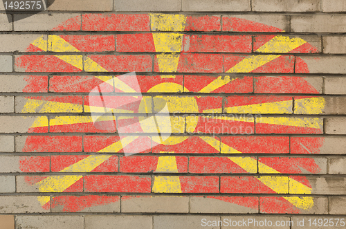 Image of flag of macedonia on grunge brick wall painted with chalk  