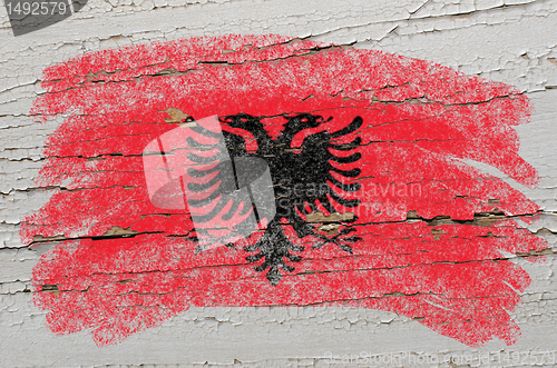 Image of flag of albania on grunge wooden texture painted with chalk  