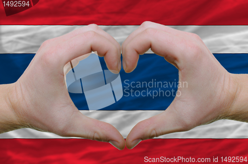 Image of Heart and love gesture showed by hands over flag of thailand bac