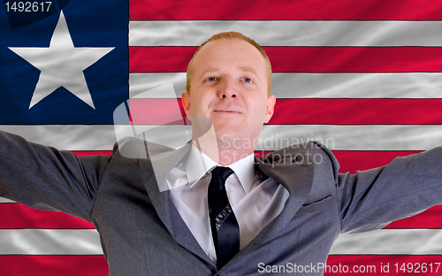 Image of happy businessman because of profitable investment in liberia st