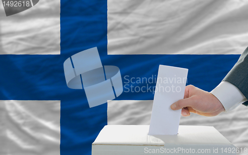 Image of man voting on elections in finland