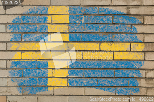 Image of flag of Sweden on grunge brick wall painted with chalk  