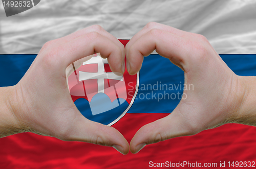 Image of Heart and love gesture showed by hands over flag of slovakia bac