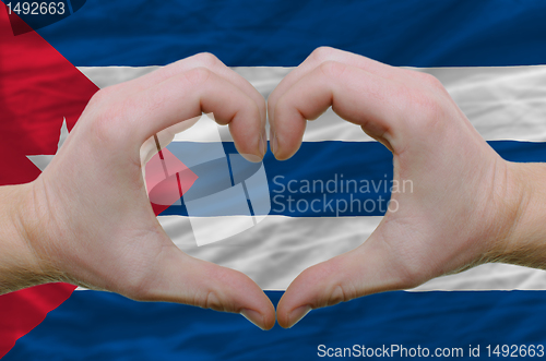 Image of Heart and love gesture showed by hands over flag of cuba backgro