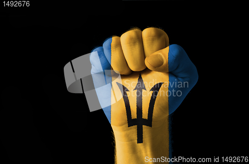 Image of Fist painted in colors of barbados flag