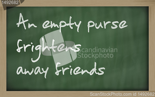 Image of " An empty purse frightens away friends " written on a blackboar