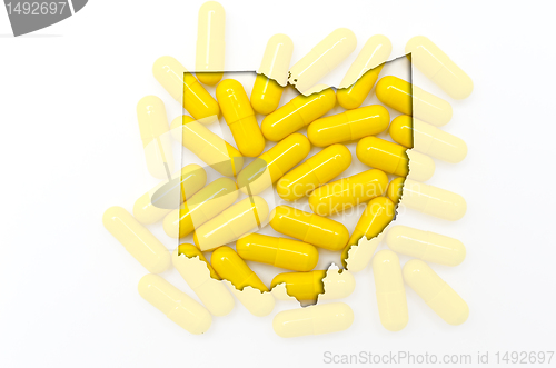 Image of Outline map of ohio with transparent pills in the background