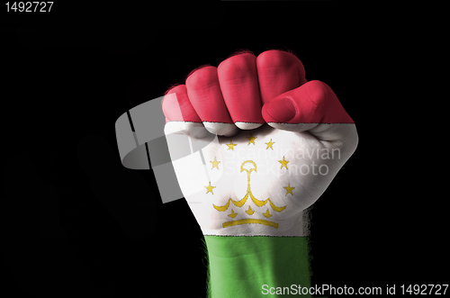 Image of Fist painted in colors of tajikistan flag