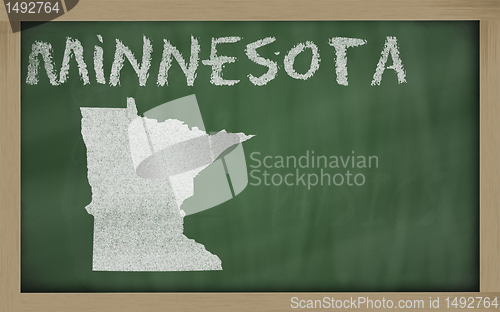 Image of outline map of minnesota on blackboard 