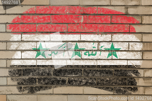 Image of flag of Iraq on grunge brick wall painted with chalk  