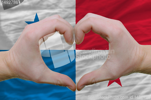 Image of Heart and love gesture showed by hands over flag of panama backg