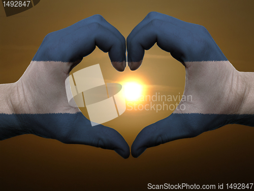 Image of Heart and love gesture by hands colored in nicaragua flag during