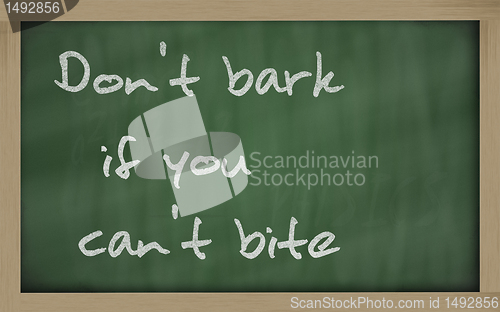 Image of " Don't bark if you can't bite " written on a blackboard