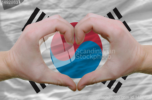 Image of Heart and love gesture showed by hands over flag of south korea 