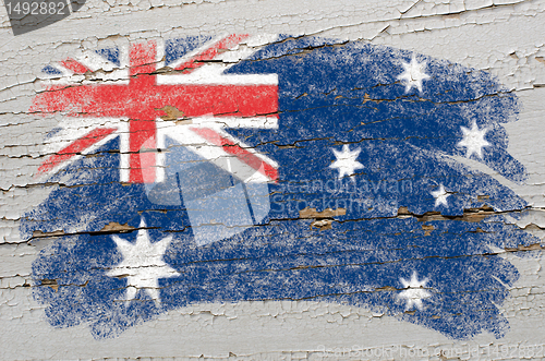 Image of flag of Australia on grunge wooden texture painted with chalk  