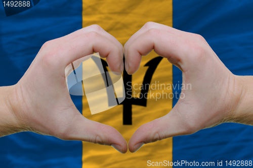 Image of Heart and love gesture showed by hands over flag of barbados bac