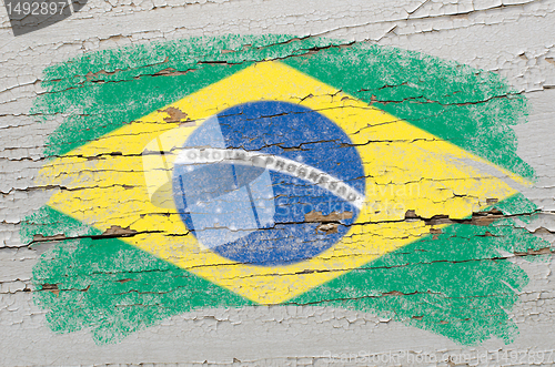 Image of flag of Brazil on grunge wooden texture painted with chalk  