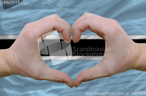 Image of Heart and love gesture showed by hands over flag of botswana bac