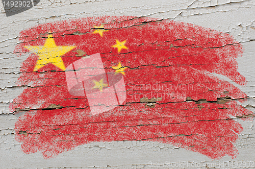 Image of flag of China on grunge wooden texture painted with chalk  