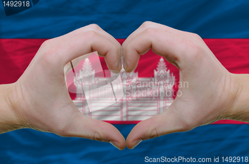 Image of Heart and love gesture showed by hands over flag of cambodia bac