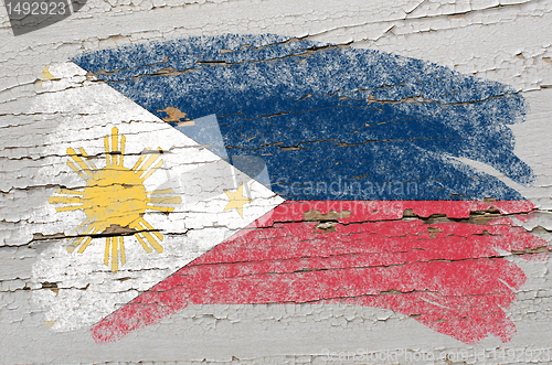 Image of flag of phillipines on grunge wooden texture painted with chalk 