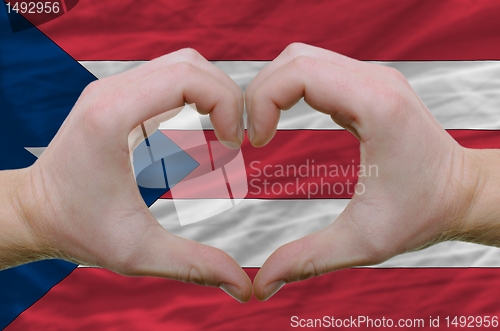 Image of Heart and love gesture showed by hands over flag of puertoricol 