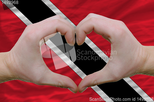 Image of Heart and love gesture showed by hands over flag of trinidad tob