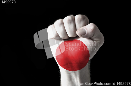 Image of Fist painted in colors of jamaica flag