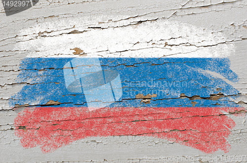 Image of flag of Russia on grunge wooden texture painted with chalk  