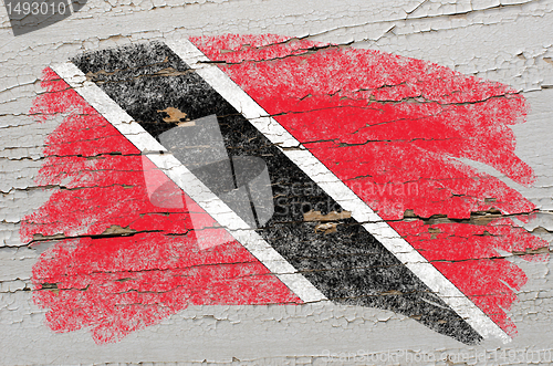 Image of flag of trinidad and tobago on grunge wooden texture painted wit