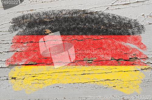 Image of flag of Germany on grunge wooden texture painted with chalk  